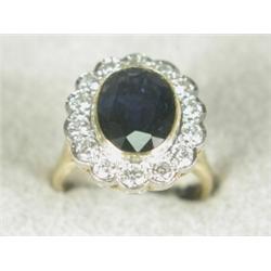 A sapphire and diamond cluster ring (sapphire approx 5cts, total diamond weight approx 1.4cts), s...