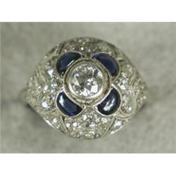 A sapphire and diamond filigree bombe ring millegrain, set in white metal (tests platinum) size K...