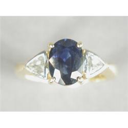 A sapphire and diamond 3-stone ring, the central oval sapphire of approx 1.75cts flanked by two t...