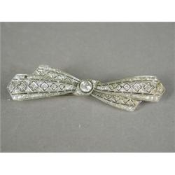 A diamond pierced bow brooch set with a single old cut stone of approx 0.50ct and encrusted with...