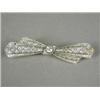Image 1 : A diamond pierced bow brooch set with a single old cut stone of approx 0.50ct and encrusted with...