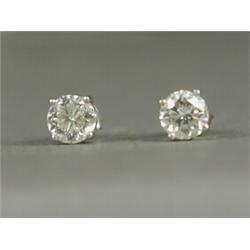 A pair of diamond solitaire stud earrings set in white metal (tests gold) Est. 2500/3000...