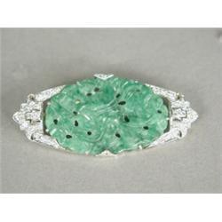 A diamond and carved jade brooch, set with approx 0.75ct of diamonds Est. 175/275...