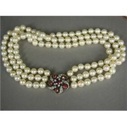 A three row 7.25mm cultured pearl choker, with a ruby and diamond clasp, 34cm long Est. 1000/1500...