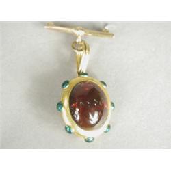 An 18ct gold Victorian brooch set with a carbuncle garnet, the reverse set with hair, with enamel...