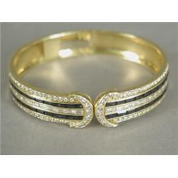 A sapphire and diamond hinged bracelet, channel set with baguette sapphires and baguette and bril...