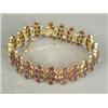 Image 1 : A garnet set fancy link bracelet set in yellow metal (tests gold) with a safety chain, 16cm long...