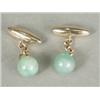Image 1 : A pair of 10ct gold and jade cufflinks Est. 60/80...