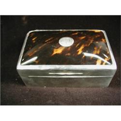 A silver table top cigarette box with a tortoiseshell lid, 1910 Est. 150/200...