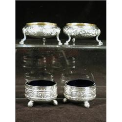 Two pairs of Victorian silver salts, the first embossed with flowers, London 1853 on hoof feet, t...