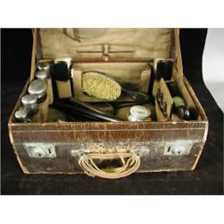 A leather case containing a toiletry set with silver topped bottles Est. 250/350...