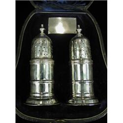 A cased pair of silver peppers, Birmingham 1897, 10cm high Est. 100/150...