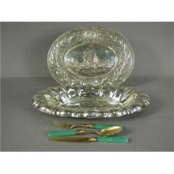 An oval embossed plaque stamped 800, 30cm long, a continental white metal oval bowl and a gilt kn...