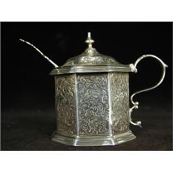 A Victorian silver hexagonal mustard pot chased with scroll work decoration, 1859, and a mustard...
