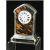 Image 1 : A small silver and tortoiseshell clock, (dial cracked), 13.5cm high Est. 250/300...