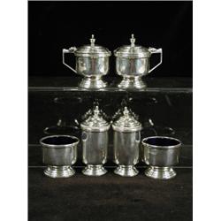 A six piece silver cruet set, of cylindrical shape with stepped lids, Sheffield 1945 Est. 250/300...