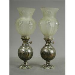 A pair of Victorian silver plated oil lamps, with planished globe bodies with moulded shades, all...