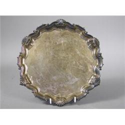 A late Victorian Mappin Bros. silver salver on three claw and ball feet, engraved with an armoria...