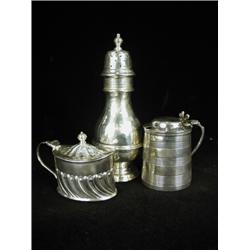 An Edwardian silver caster, London 1906, 18.5cm high, a half fluted mustard pot, Sheffield 1928,...