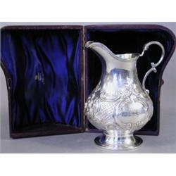 A Victorian silver cream jug with repousse decoration, London 1859, maker A.S., 13cm high, in a f...