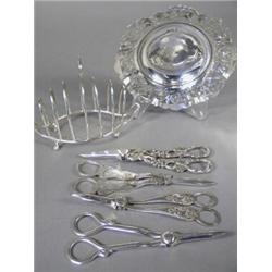 A Victorian silver toast rack, London 1896, maker W. Hutton & Sons Ltd., and a George V silver pi...