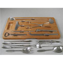 A late 20th century Georg Jensen stainless steel wine and cheese serving cutlery in fitted wooden...
