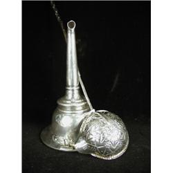 A George III silver and whale bone handled toddy ladle, and a silver plated winefunnel, early 19t...