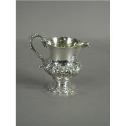 A William IV silver milk jug repousse decorated with flowering foliage, 1835, 12cm high Est. 200/...