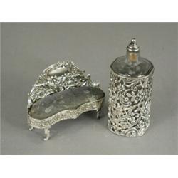 A silver pin cushion in the form of a settee, 1901, 11cm long, and a glass scent bottle in a silv...