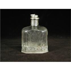 A good 19th/20th century continental perfume bottle with floral engraved sides and repousse white...