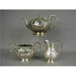 A silver three piece tea set, with an initialled cartouche, teapot, Sheffield 1859, jug and sucri...