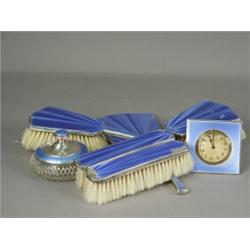 A seven piece silver and enamel dressing table set (with damage), clock 7cm high, 1929 Est. 140/1...