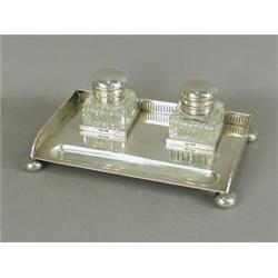A silver inkstand with a pierced gallery and two cut glass inkwells, 1910, 21.5cm wide Est. 300/4...