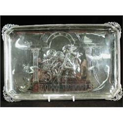 A rectangular silver tray embossed and chased with a female musical trio on a balcony, by Charles...