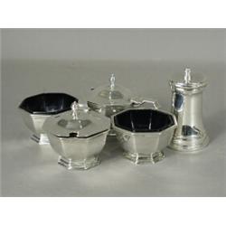 A Victorian four piece silver condiment set, each piece with blue glass liners, hallmarked London...