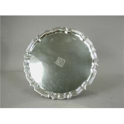 A late George V silver salver supported upon three feet, hallmarked Sheffield 1934, 31cm diameter...