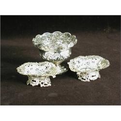 A small silver rose bowl with repousse decoration, Chester 1898 (?), 9cm diameter, and a pair of...