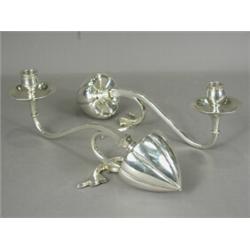 A pair of W.A.S. Benson plated candlesticks, of scrolling elongated design, with counterweighted...