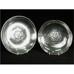Two Keswick School plated dishes, each with a floral head motif in the centre, each marked 'Firth...