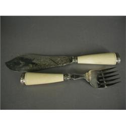 A pair of Victorian fish servers with engraved plated blades, ivory handles and silver finials Es...