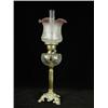 Image 1 : A 19th century oil lamp, with a tinted shade above a moulded glass reservoir supported upon a...