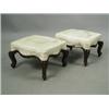 Image 1 : A pair of mid Victorian walnut footstools, the gold damask seats of serpentine outline on moul...