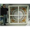 Image 1 : A late Victorian stained and leaded glass window in a wooden frame, 152 x 152cm Est. 300/500...