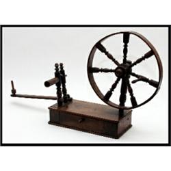 A George IV mahogany spinning wheel, circa 1830, on a rectangular base with single drawer and kno