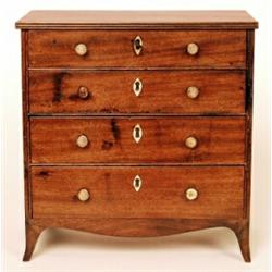 An early 19th Century mahogany miniature chest of four graduated long drawers, turned ivory handl