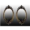 Image 1 : A pair of Victorian oval giltwood girandoles, circa 1860, the scrolled acanthus and husk pediment