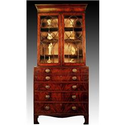 A late George III mahogany and ebony strung secretaire bookcase, circa 1820, the concave cornice