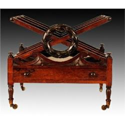 A George IV rosewood canterbury, circa 1825, the three divisions of X frame slat form centring a