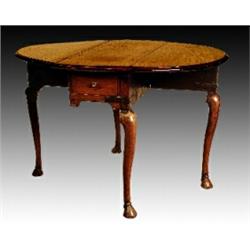 A George II mahogany oval drop leaf table, fitted with a single end drawer, on cabriole legs with