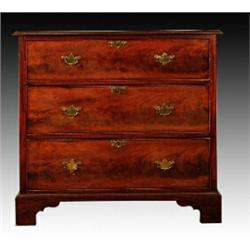 A late George III mahogany chest, with three graduated cockbeaded drawers, later brass escutcheon